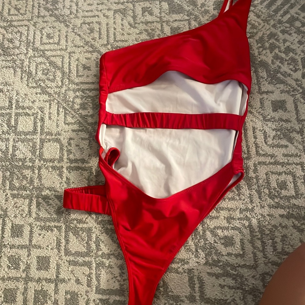 SHEIN ONE PIECE WITH ONE SHOULDER AND CUT OUTS.